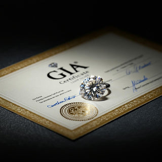 A sparkling round brilliant cut diamond displayed on a GIA certification document, featuring the official GIA logo, gold seal and grading details.