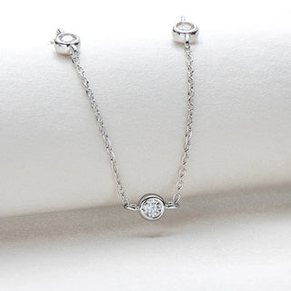 Round Cut Bezel Moissanite Necklace in 18K gold with minimalist bezel setting and adjustable chain.