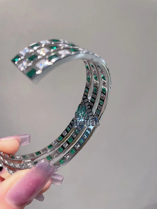 Emerald Vine Bracelet in sterling silver, featuring a vivid lab-created emerald sapphire surrounded by delicate side stones, evoking natural elegance.