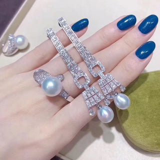 Lake-gray Lady of the Lake hoop earrings in 925 sterling silver with a central freshwater pearl and lab-created sapphire accents.