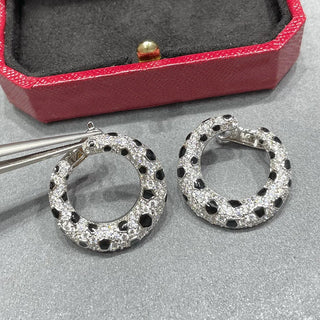 Leopard Spots Earrings – Sterling silver earrings with a spotted pattern, adorned with lab-created sapphires, blending boldness and sophistication.