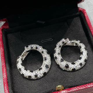 Leopard Spots Earrings – Sterling silver earrings with a spotted pattern, adorned with lab-created sapphires, blending boldness and sophistication.