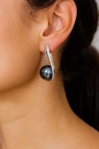 Midnight Orbit Earrings: 925 sterling silver hoop earrings with a central freshwater pearl encircled by lab-created sapphire stones.