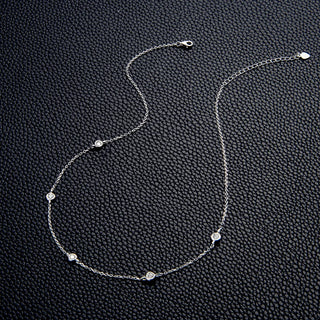 Round Cut Bezel Moissanite Necklace in 18K gold with minimalist bezel setting and adjustable chain.