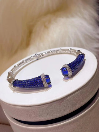 Silver Sapphire Mirage Bangle featuring lab sapphires in a polished silver finish – elegant sapphire bangle bracelet by Azzallure.