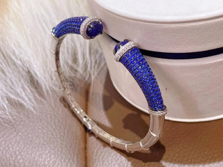 Silver Sapphire Mirage Bangle featuring lab sapphires in a polished silver finish – elegant sapphire bangle bracelet by Azzallure.