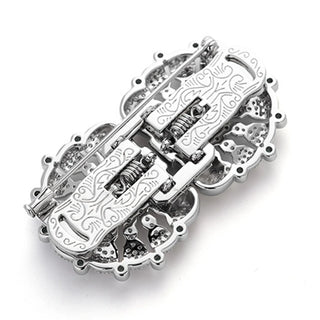 Vintage emerald clasp brooch in sterling silver with central green emerald, 57 mm wide and weighing 39 g.