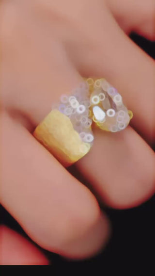 Water Drop Cocktail Ring with bold pear-cut lab sapphire and scattered stones on a textured gold band